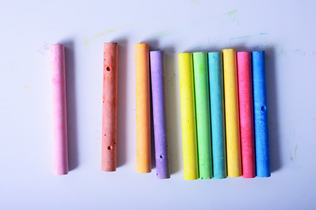 rainbow colored chalk arranged on a white background, chalk isolatedの写真素材