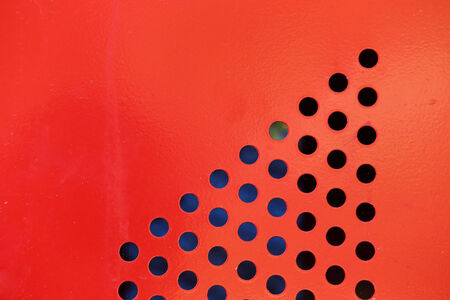 Background of red steel metal with circle perforated holes
の写真素材