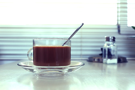 glass cup of coffee on white tableの写真素材