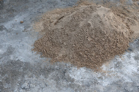 pile sand on cement floorの写真素材