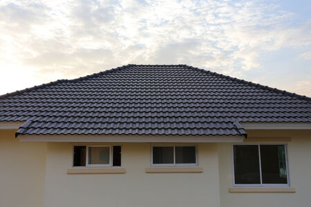black tiles roof on a new house with sunset skyのeditorial素材