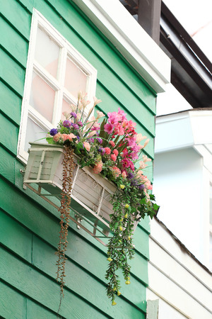 Window decorated with fresh flowers in boxの写真素材
