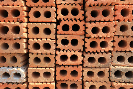 Stack of red bricks, bricks used for building constructionの写真素材