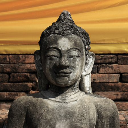 buddha statue sculpture stone with golden face in temple buddhismの写真素材