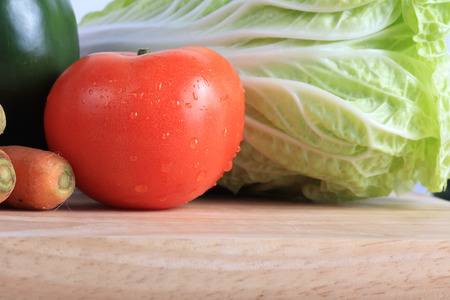 tomato and cabbage on wooden chopping board prepare cookingの写真素材