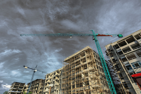 Construction site with cranes on blue sky backgroundの写真素材