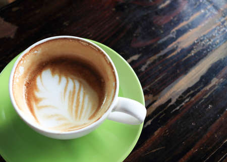 coffee espresso, white coffee cup and green saucer on wooden tableの写真素材