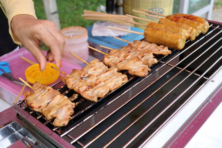 grilled pork and sausage on a barbecue grill, thai food