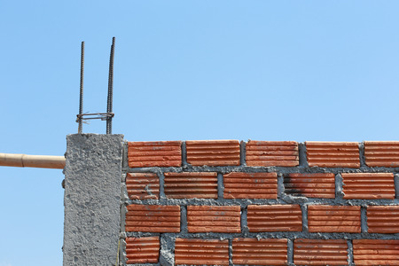 brick wall and pole house in residential building construction siteの写真素材