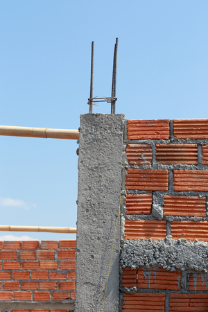 brick wall and pole house in residential building construction siteの写真素材