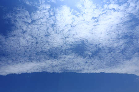 white clouds in the blue sky backgroundの写真素材
