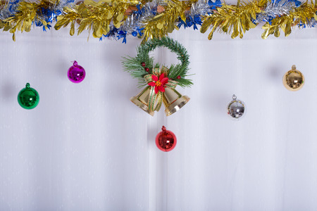 christmas background, bell and ball decorate on white curtainの写真素材