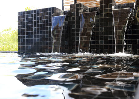 flowing water decorated in swimming poolの写真素材