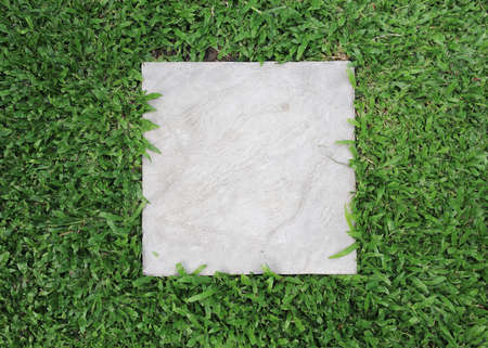 cement block with green grass background