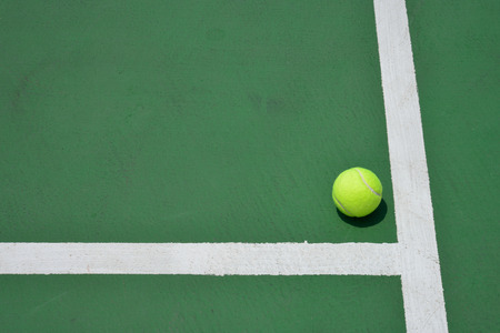 tennis ball on green court, sport backgroundの写真素材