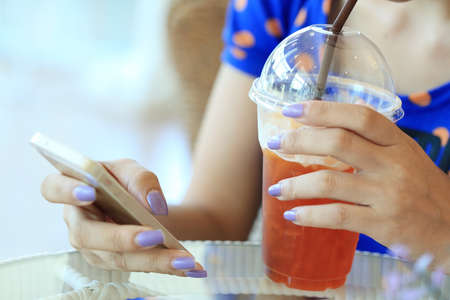 woman using a smart phone in cafeの写真素材