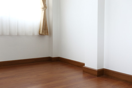 white mortar wall and wood floor in the roomの写真素材