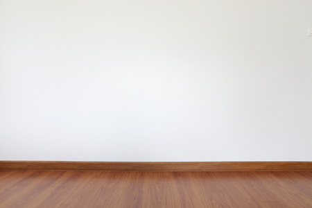 white mortar wall and wood floor in the roomの写真素材