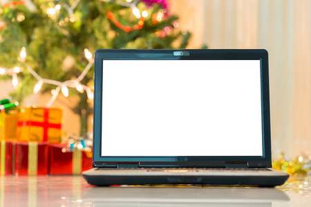 laptop with gift box and christmas lights backgroundの写真素材