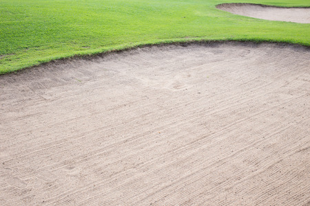 sand bunker and green grass of golf courseのeditorial素材