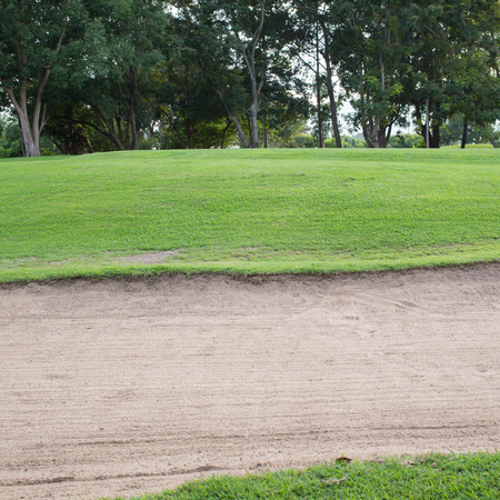 sand bunker and green grass of golf courseのeditorial素材