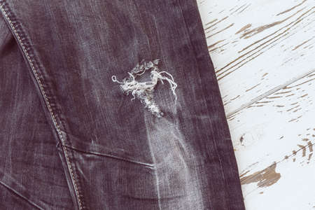 black jeans on white wood, retro tone imageの写真素材