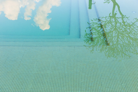 reflection sky and tree of water in swimming poolの写真素材