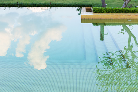reflection sky and tree of water in swimming poolの写真素材