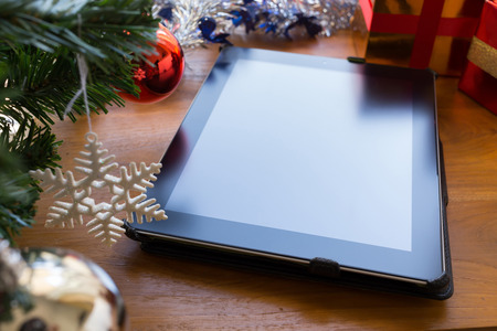 black tablet on table wood with christmas decorationの写真素材