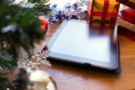 black tablet on table wood with christmas decorationの写真素材