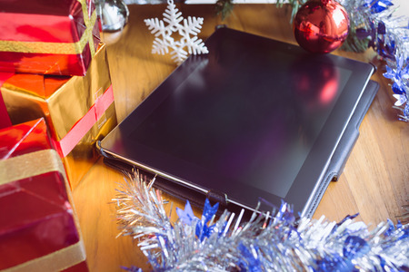 black tablet on table wood with christmas decorationの写真素材
