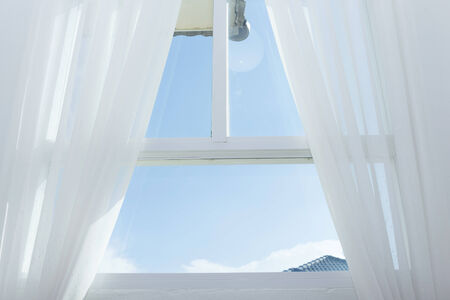 white curtain on the window with blue sky