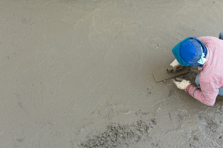 plasterer concrete cement worker plastering flooring of house constructionの写真素材