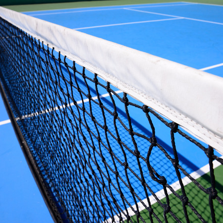 net on blue tennis court sport backgroundの写真素材