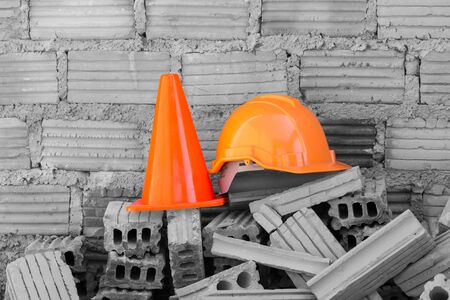 construction helmet safety and cone in construction site with bricksの写真素材