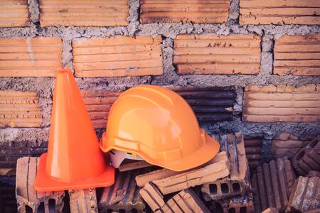 construction helmet safety and cone in construction site with bricksの写真素材