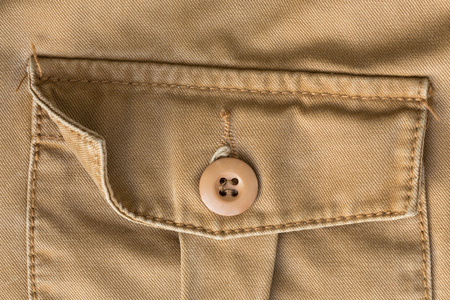 front pocket on brown shirt textile texture background