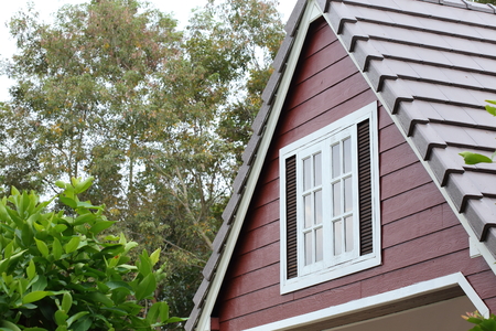 attic with white wood window on the roof houseの写真素材