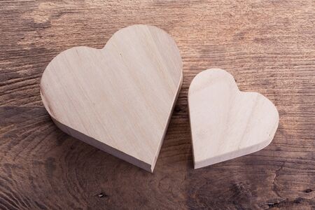 heart brown wood box on wood background, abstract love backgroundの写真素材