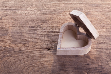 heart brown wood box on wood background, abstract love backgroundの写真素材