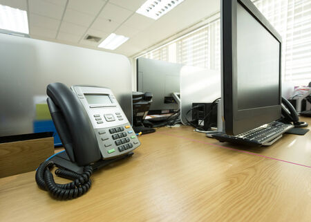table work in office with telephone and computer pcの写真素材