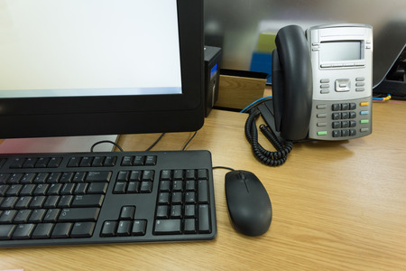 table work in office with telephone and computer pcの写真素材