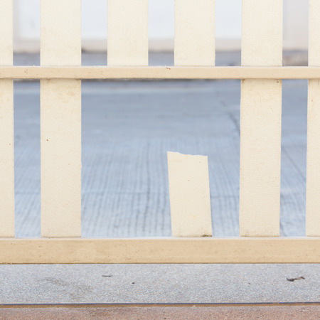 white wood fence of broken damaged