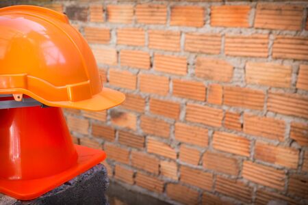 construction helmet safety and cone in construction site with bricksの写真素材