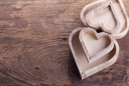 heart brown wood box on wood background, abstract love backgroundの写真素材