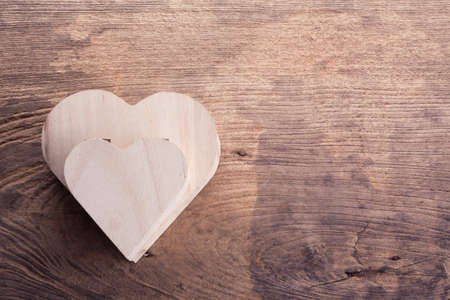 heart brown wood box on wood background, abstract love backgroundの写真素材