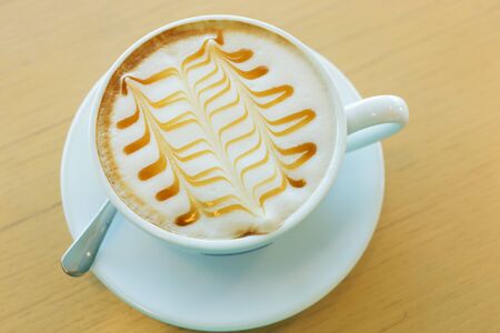 caramel macchiato hot of coffee drink on wooden table in the cafeの写真素材
