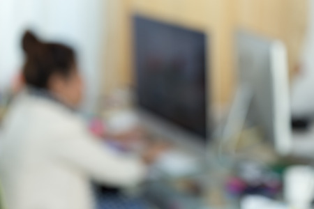 working woman with computer, image blur backgroundの写真素材