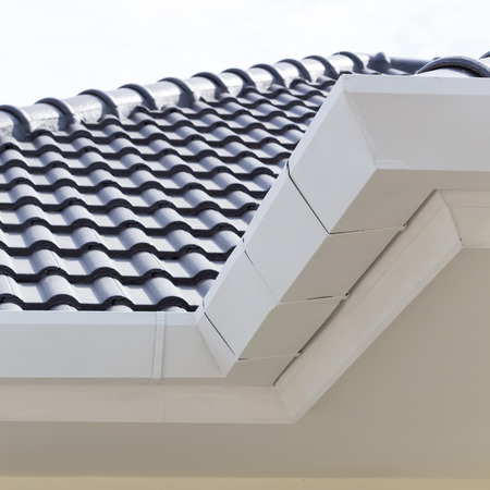 white gutter on the roof top of house