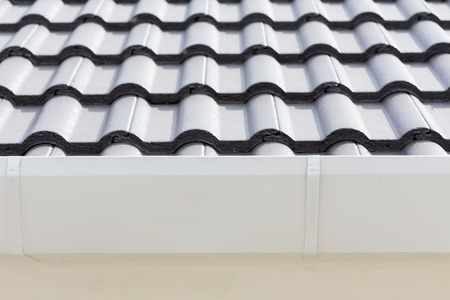 white gutter on the roof top of house